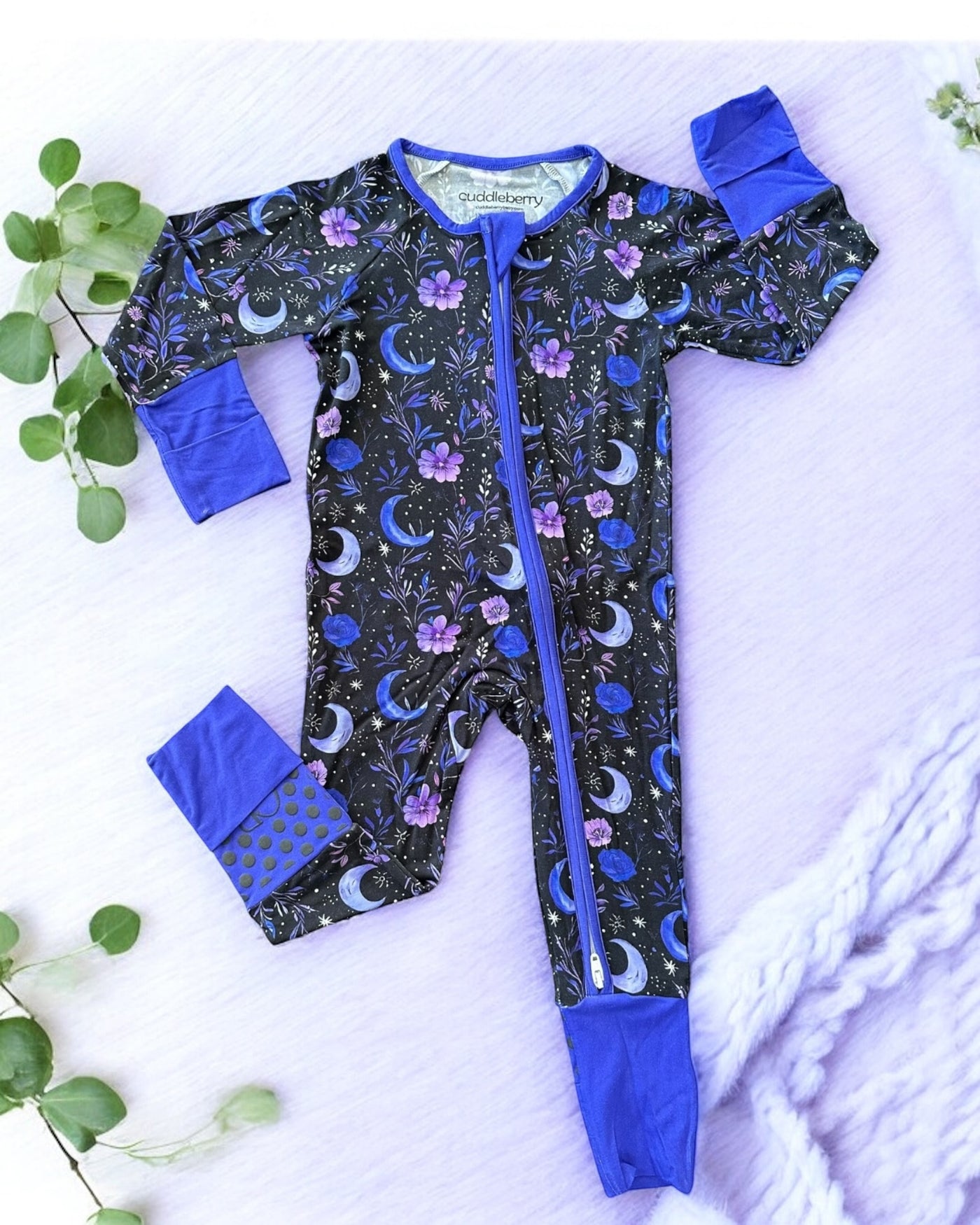 Purple Moonbeam bamboo zipper sleeper for babies with floral and moon patterns, designed for comfort and warmth.