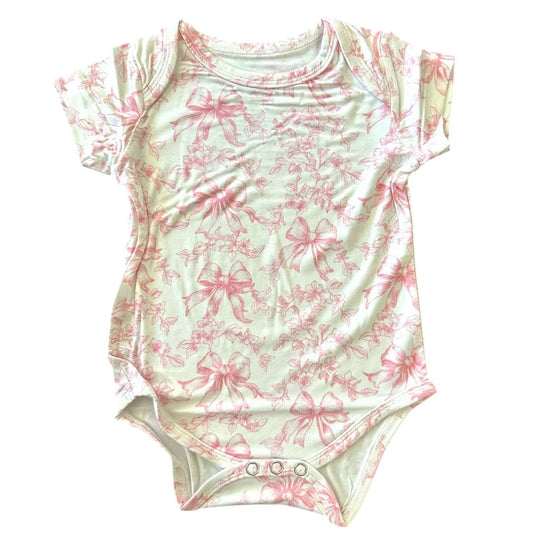 Toile Bows Bamboo Bodysuit in light green with pink bow pattern, soft bamboo fabric, short sleeves, functional buttons.