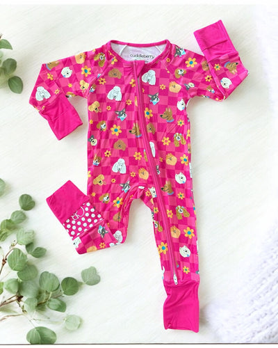 Checkered Pups bamboo zipper sleeper for babies in vibrant pink with cute dog and flower patterns.