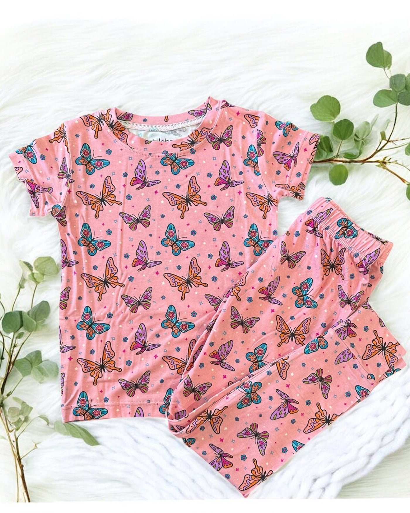 Pink butterfly short sleeve two-piece pajamas for kids, featuring colorful butterfly prints on a soft bamboo fabric.