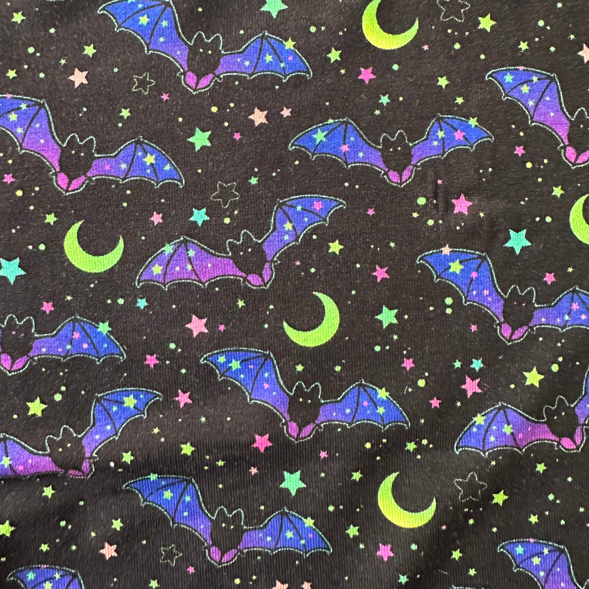 Cosmic Bats Long Sleeve Two-Piece PJ's fabric featuring colorful bats, stars, and crescent moons on a dark background.