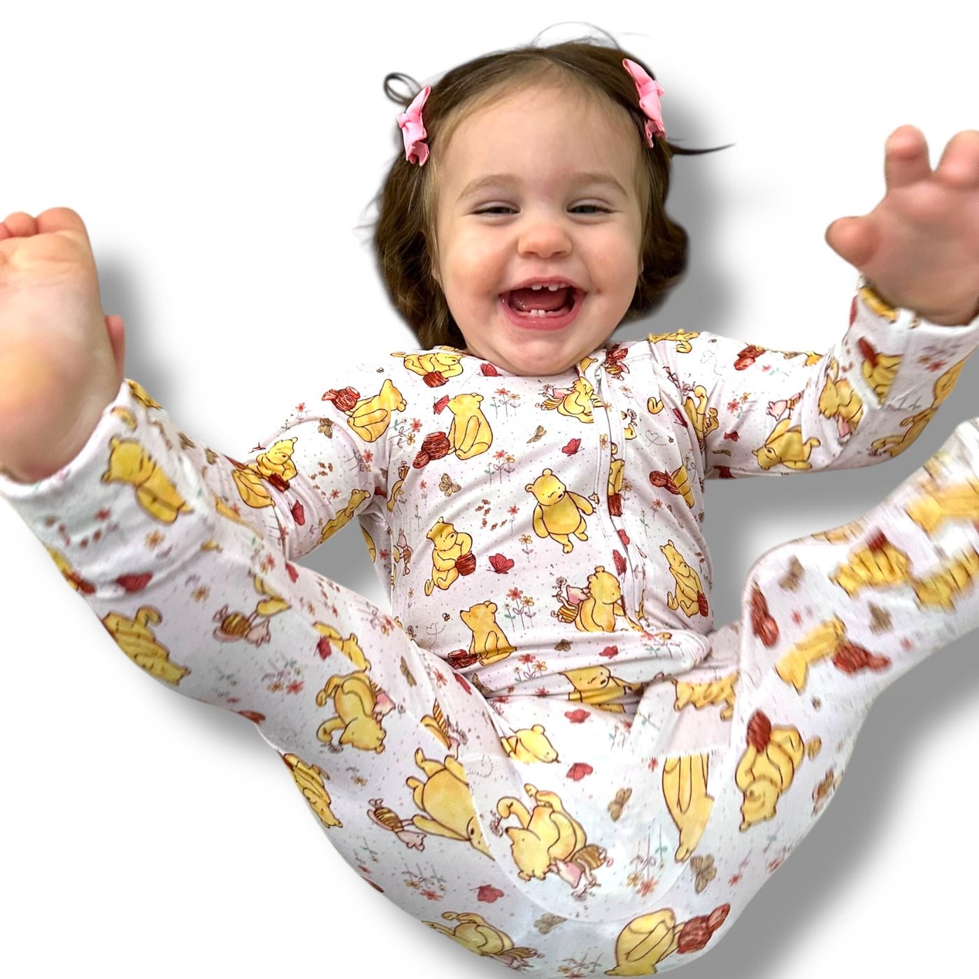 Cute toddler joyfully playing in Classic Pooh zipper sleeper with playful designs.
