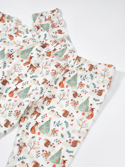 Woodland Christmas Animal print bamboo pajamas for kids featuring trees, deer, and festive motifs.