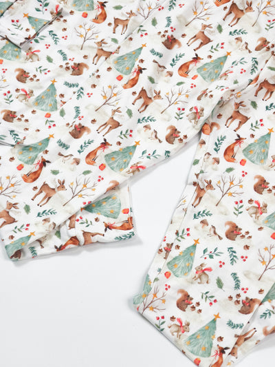 Woodland Christmas two-piece bamboo pajamas featuring festive animal and tree patterns, perfect for cozy holiday sleepwear.